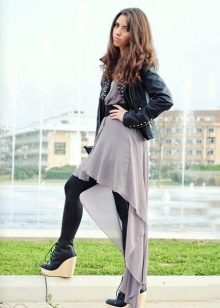 Asymmetric dress combined with a leather jacket and tight tights