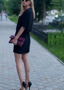 Shirt dress in combination with a clutch and stiletto heels