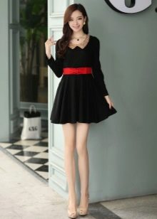 Schwarzes kurzes Kleid mit Sonnenrock und rotem Gürtel