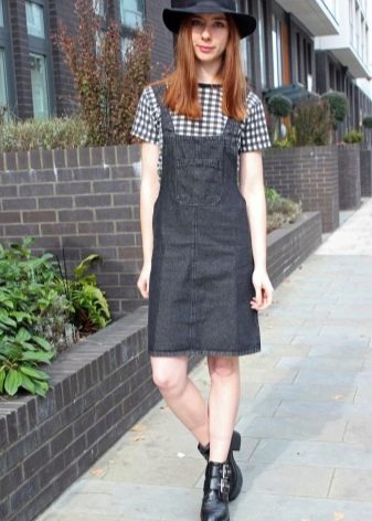 Pinafore dress combined with a T-shirt and a hat