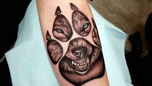 Wolf paw tattoo: meaning and sketches