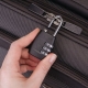 How to open the combination lock on the suitcase?