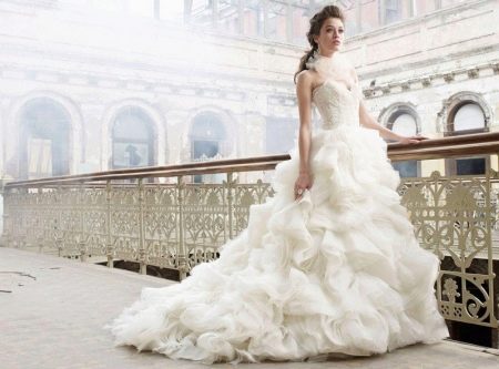 Wedding dress with a skirt made of flounces with a train